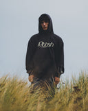 Faded black Rbbsh Core hoodie with a relaxed fit, featuring a drawstring hood and ribbed cuffs, displayed on a hanger.