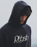 Rbbsh Core Rbbsh hoodie in faded black, showing the relaxed fit and soft fabric with front pocket and hood detail.